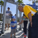 Henry Borboa, right, screens a young fan at Dodger Stadium prior to an opening day baseball game between the Los Angeles Dodgers and the San Diego Padres, Monday, April 6, 2015, in Los Angeles. (AP Photo/Mark J. Terrill)