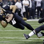 New Orleans Saints quarterback Drew Brees (9) is tackled in the first half of an NFL football game against the Baltimore Ravens in New Orleans, Monday, Nov. 24, 2014. (AP Photo/Jonathan Bachman)