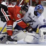 Chicago Blackhawks' Brandon Saad, left, collides with Tampa Bay Lightning goalie Ben Bishop during the second period in Game 6 of the NHL hockey Stanley Cup Final series on Monday, June 15, 2015, in Chicago. (AP Photo/Nam Y. Huh)