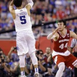 Duke's Tyus Jones (5) shoots a three point basket against Wisconsin's Frank Kaminsky (44) during the second half of the NCAA Final Four college basketball tournament championship game Monday, April 6, 2015, in Indianapolis. (AP Photo/Michael Conroy)