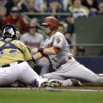 Arizona Diamondbacks' Chris Owings, right, slides safely home ahead of the tag by Milwaukee Brewers' Martin Maldonado (12) during the second inning of a baseball game Saturday, May 30, 2015, in Milwaukee. Owings scored on a double by the Diamondbacks Nick Ahmed. (AP Photo/Jeffrey Phelps)