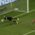 United States' goalkeeper Tim Howard makes a save as Belgium's Vincent Kompany, right, looks on during the World Cup round of 16 soccer match between Belgium and the USA at the Arena Fonte Nova in Salvador, Brazil, Tuesday, July 1, 2014. (AP Photo/Themba Hadebe)