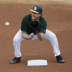 Actor Will Ferrell warms up at shortstop for the Oakland Athletics prior to the first inning of a spring training baseball game against the Seattle Mariners, Thursday, March 12, 2015, in Mesa, Ariz. Telling everyone "I'm a five-tool guy," Ferrell was off on his barnstorming tour Thursday through five Arizona spring training games. (AP Photo/Matt York)