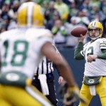 Green Bay Packers' Aaron Rodgers (12) looks to pass to Randall Cobb (18) during the first half of the NFL football NFC Championship game against the Seattle Seahawks Sunday, Jan. 18, 2015, in Seattle. (AP Photo/Elaine Thompson)