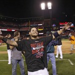 St. Louis Cardinals' Yadier Molina celebrates with fans on the field after the Cardinals defeated the Los Angeles Dodgers 3-2, in Game 4 of baseball's NL Division Series Tuesday, Oct. 7, 2014, in St. Louis. (AP Photo/Charles Rex Arbogast)