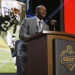 Former New England Patriots cornerback Ty Law announces that the Patriots selects Stanford Jordan Richards as the 64th pick in the second round of the 2015 NFL Football Draft, Friday, May 1, 2015, in Chicago. (AP Photo/Charles Rex Arbogast)