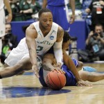Manhattan's RaShawn Stores, front, dives over Hampton's Ke'Ron Brown for a loose ball in the second half of a first round NCAA tournament basketball game Tuesday, March 17, 2015 in Dayton, Ohio. (AP Photo/Skip Peterson)