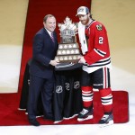 Chicago Blackhawks' Duncan Keith, right, is awarded the The Conn Smythe Trophy by commissioner Gary Bettman after the Blackhawks 2-0 victory over the Tampa Bay Lightning in Game 6 of the NHL hockey Stanley Cup Final series on Monday, June 15, 2015, in Chicago. (AP Photo/Charles Rex Arbogast)
