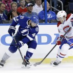 Montreal Canadiens center Daniel Briere (48) strips Tampa Bay Lightning center Nate Thompson (44) of the puck during the first period of Game 1 of a first-round NHL hockey playoff series on Wednesday, April 16, 2014, in Tampa, Fla. (AP Photo/Chris O'Meara)
