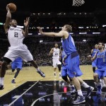 San Antonio Spurs' Kawhi Leonard (2) makes an off-balance shot over Dallas Mavericks' Dirk Nowitzki (41), of Germany, during the second half of Game 1 of the opening-round NBA basketball playoff series on Sunday, April 20, 2014, in San Antonio. San Antonio won 90-85. (AP Photo/Eric Gay)