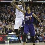 Sacramento Kings center DeMarcus Cousins, left, shoots the game-winning shot, over Phoenix Suns forward Markieff Morris to give the Kings a 85-83 win in an NBA basketball game in Sacramento, Calif., Sunday, Feb. 8, 2015. (AP Photo/Rich Pedroncelli)