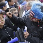 Rosa Chavarria, right, paints colors of the United States on her son Pablo's face before watching a 2014 World Cup soccer match between the United States and Germany at a public viewing party in San Francisco, Thursday, June 26, 2014. (AP Photo/Jeff Chiu)
