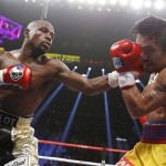 Floyd Mayweather Jr., left, lands a left to the head of Manny Pacquiao, from the Philippines, during their welterweight title fight on Saturday, May 2, 2015 in Las Vegas. (AP Photo/John Locher)