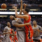 New Orleans Pelicans' Alexis Ajinca, of France, right, is fouled by Phoenix Suns' Markieff Morris (11) during the first half of an NBA basketball game, Thursday, March 19, 2015, in Phoenix. (AP Photo/Matt York)