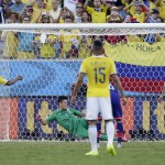 Colombia's Juan Cuadrado scores a penalty kick past Japan's goalkeeper Eiji Kawashima during the group C World Cup soccer match between Japan and Colombia at the Arena Pantanal in Cuiaba, Brazil, Tuesday, June 24, 2014. (AP Photo/Felipe Dana)