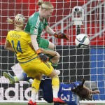 Sweden goalkeeper Hedvig Lindahl (1) saves the header from United States' Alex Morgan (13) as Sweden's Amanda Ilestedt (14) defends during second-half FIFA Women's World Cup soccer game action in Winnipeg, Manitoba, Canada, Friday, June 12, 2015. T
