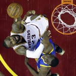 Cleveland Cavaliers forward LeBron James (23) puts up a shot against Golden State Warriors forward Draymond Green (23) during the first half of Game 6 of basketball's NBA Finals in Cleveland, Tuesday, June 16, 2015. (AP Photo/Tony Dejak)
