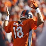 Denver Broncos quarterback Peyton Manning (18) signals a touchdown against the Arizona Cardinals during the second half of an NFL football game, Sunday, Oct. 5, 2014, in Denver. (AP Photo/Jack Dempsey)