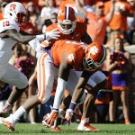 Clemson defensive end Corey Crawford (93) picks up a North Carolina State fumble as teammate Vic Beasley looks on and North Carolina State running back Shadrach Thornton (10) defends during the first half of an NCAA college football game, Saturday, Oct. 4, 2014, in Clemson, S.C. (AP Photo/Rainier Ehrhardt)