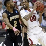Arkansas guard Rashad Madden (00) drives into Wofford guard Karl Cochran (2) during the first half of an NCAA tournament second round college basketball game Thursday, March 19, 2015, in Jacksonville, Fla. (AP Photo/John Raoux)