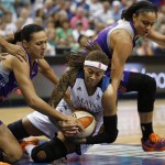 Minnesota Lynx guard Seimone Augustus (33) fights for possession of the ball with Phoenix Mercury forward Mistie Bass, left, and forward Candice Dupree, right, during the first half of Game 2 of a WNBA basketball Western Conference finals, Sunday, Aug. 31, 2014, in Minneapolis. The Lynx won 82-77. (AP Photo/Stacy Bengs)