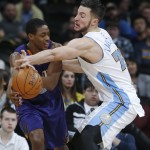 Denver Nuggets forward Joffrey Lauvergne, right, of France, tries to steal the ball from Phoenix Suns guard Brandon Knight late in the fourth quarter of an NBA basketball game Wednesday, Feb. 25, 2015, in Denver. The Suns won 110-96. (AP Photo/David Zalubowski)