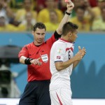 Referee Benjamin Williams, of Australia, gives Costa Rica's Oscar Duarte a red cart and ejects him during the World Cup round of 16 soccer match between Costa Rica and Greece at the Arena Pernambuco in Recife, Brazil, Sunday, June 29, 2014. (AP Photo/Petr David Josek)
