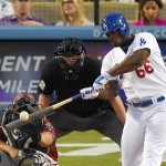 Los Angeles Dodgers' Yasiel Puig, right, hits a three-run home run as Arizona Diamondbacks catcher Welington Castillo, left, and home plate umpire Gerry Davis watch during the second inning of a baseball game, Wednesday, June 10, 2015, in Los Angeles. (AP Photo/Mark J. Terrill)