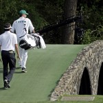  Bubba Watson walks across the Hogan Bridge with his caddie Ted Scott during the fourth round of the Masters golf tournament Sunday, April 13, 2014, in Augusta, Ga. (AP Photo/Darron Cummings)