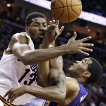 Cleveland Cavaliers' Tristan Thompson, left, from Canada, and Phoenix Suns' T.J. Warren become entangled during the fourth quarter of an NBA basketball game Saturday, March 7, 2015, in Cleveland. The Cavaliers defeated the Suns 89-79. (AP Photo/Tony Dejak)