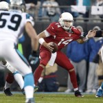 Arizona Cardinals' Ryan Lindley (14) scrambles under pressure from Carolina Panthers players in the first half of an NFL wild card playoff football game in Charlotte, N.C., Saturday, Jan. 3, 2015. (AP Photo/Bob Leverone)