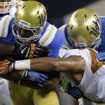 UCLA running back Jordon James protects the ball during the first half of an NCAA college football game against Texas, Saturday, Sept. 13, 2014, in Arlington, Texas. (AP Photo/Tony Gutierrez)