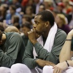 Milwaukee Bucks' Michael Carter-Williams, left, Khris Middleton and Ersan Ilyasova, right, watch the second half of Game 6 against the Chicago Bulls during an NBA basketball first-round playoff series Thursday, April 30, 2015, in Milwaukee. Chicago won 120-66 to win the series. (AP Photo/Jeffrey Phelps)
