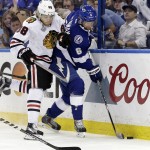 Tampa Bay Lightning defenseman Anton Stralman, of Sweden, knocks the pack away from Chicago Blackhawks right wing Patrick Kane, left, during the first period in Game 2 of the NHL hockey Stanley Cup Final in Tampa, Fla., Saturday, June 6, 2015. (AP Photo/Chris O'Meara)