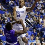 Kentucky's Aaron Harrison (2) is fouled by Grand Canyon's De'Andre Davis during the first half of an NCAA college basketball game, Friday, Nov. 14, 2014, in Lexington, Ky. (AP Photo/James Crisp)