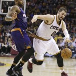 Cleveland Cavaliers' Kevin Love, right, drives past Phoenix Suns' P.J. Tucker, left, during the second quarter of an NBA basketball game Saturday, March 7, 2015, in Cleveland. (AP Photo/Tony Dejak)