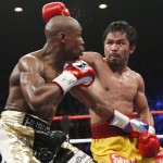 Manny Pacquiao, from the Philippines, right, punches Floyd Mayweather Jr., during their welterweight title fight on Saturday, May 2, 2015 in Las Vegas. (AP Photo/John Locher)