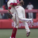 Philadelphia Phillies shortstop Andres Blanco, left, and second baseman Cesar Hernandez (16) embrace after defeating the Arizona Diamondbacks 6-0 in a baseball game, Sunday, May 17, 2015, in Philadelphia. (AP Photo/Laurence Kesterson)