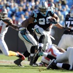 Carolina Panthers' Jonathan Stewart (28) runs past Tampa Bay Buccaneers' Lavonte David (54) in the first half of an NFL football game in Charlotte, N.C., Sunday, Dec. 14, 2014. (AP Photo/Mike McCarn)