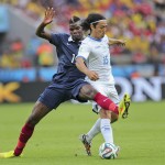 France's Paul Pogba, left, challenges Honduras' Roger Espinoza during the group E World Cup soccer match between France and Honduras at the Estadio Beira-Rio in Porto Alegre, Brazil, Sunday, June 15, 2014. (AP Photo/David Vincent)