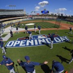 Members of the San Diego Padres warm up prior to an opening day baseball game against the Los Angeles Dodgers, Monday, April 6, 2015, in Los Angeles. (AP Photo/Mark J. Terrill)