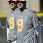 Dallas Cowboys' Tony Romo, right, and Detroit Lions Matthew Stafford watch during a practice session at Luke Air Force Base for the NFL Football Pro Bowl Thursday, Jan. 22, 2015, in Glendale, Ariz. (AP Photo/David J. Phillip)