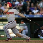  Arizona Diamondbacks' Chris Owings, left, follows the flight of his solo home run with Colorado Rockies catcher Wilin Rosario in the fourth inning of a baseball game in Denver on Tuesday, June 3, 2014. (AP Photo/David Zalubowski)