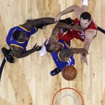 New Orleans Pelicans forward Ryan Anderson goes to the basket against Golden State Warriors guard Andre Iguodala and forward Draymond Green, left, during the first half of Game 3 of a first-round NBA basketball playoff series in New Orleans, Thursday, April 23, 2015. (AP Photo/Gerald Herbert)