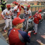 St. Louis Cardinals' Kolten Wong (16) is greeted in the dugout after a home run against the San Francisco Giants during the third inning of Game 4 of the National League baseball championship series Wednesday, Oct. 15, 2014, in San Francisco. (AP Photo/Jeff Roberson)