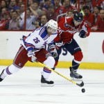 New York Rangers right wing Martin St. Louis (26) races with the puck ahead of Washington Capitals defenseman John Carlson (74) during the second period of Game 3 in the second round of the NHL Stanley Cup hockey playoffs, Monday, May 4, 2015, in Washington. (AP Photo/Alex Brandon)