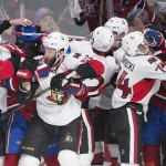 Players from the Ottawa Senators and the Montreal Canadiens fight during the third period of Game 5 of a first-round NHL hockey playoff series, Friday, April 24, 2015, in Montreal. (Graham Hughes/The Canadian Press via AP)
