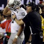 Oregon head coach Mark Helfrich talks to Marcus Mariota during the first half of the NCAA college football playoff championship game against Ohio State Monday, Jan. 12, 2015, in Arlington, Texas. (AP Photo/LM Otero)