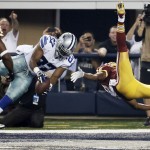 Dallas Cowboys strong safety J.J. Wilcox (27) intercepts a ball meant for Washington Redskins wide receiver Andre Roberts, right, during the first half of an NFL football game, Monday, Oct. 27, 2014, in Arlington, Texas. (AP Photo/Brandon Wade)