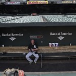 Chicago White Sox catcher Tyler Flowers sits in the dugout of an empty stadium before playing the Baltimore Orioles in a baseball game, Wednesday, April 29, 2015, in Baltimore. Due to security concerns the game was closed to the public. (AP Photo/Gail Burton)